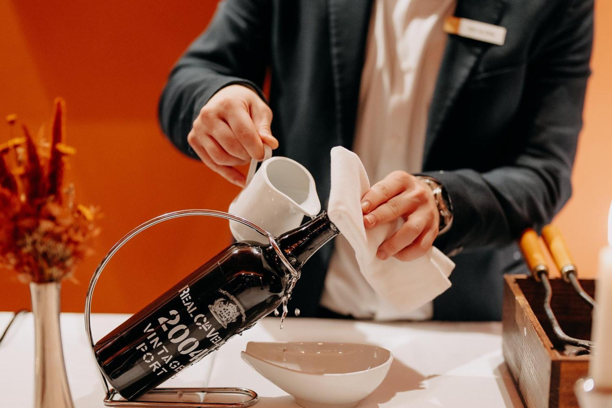 Casa Da Companhia, Vignette Collection By Ihg Hotel Porto Exterior foto A sommelier opening a bottle of wine